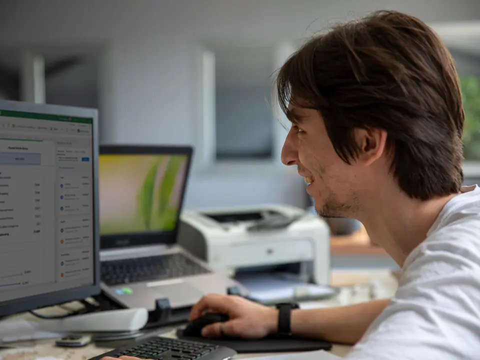 An office employee using business management software on a computer
